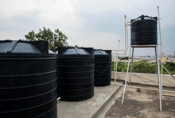 Rooftop water storage tanks installed on a residential property